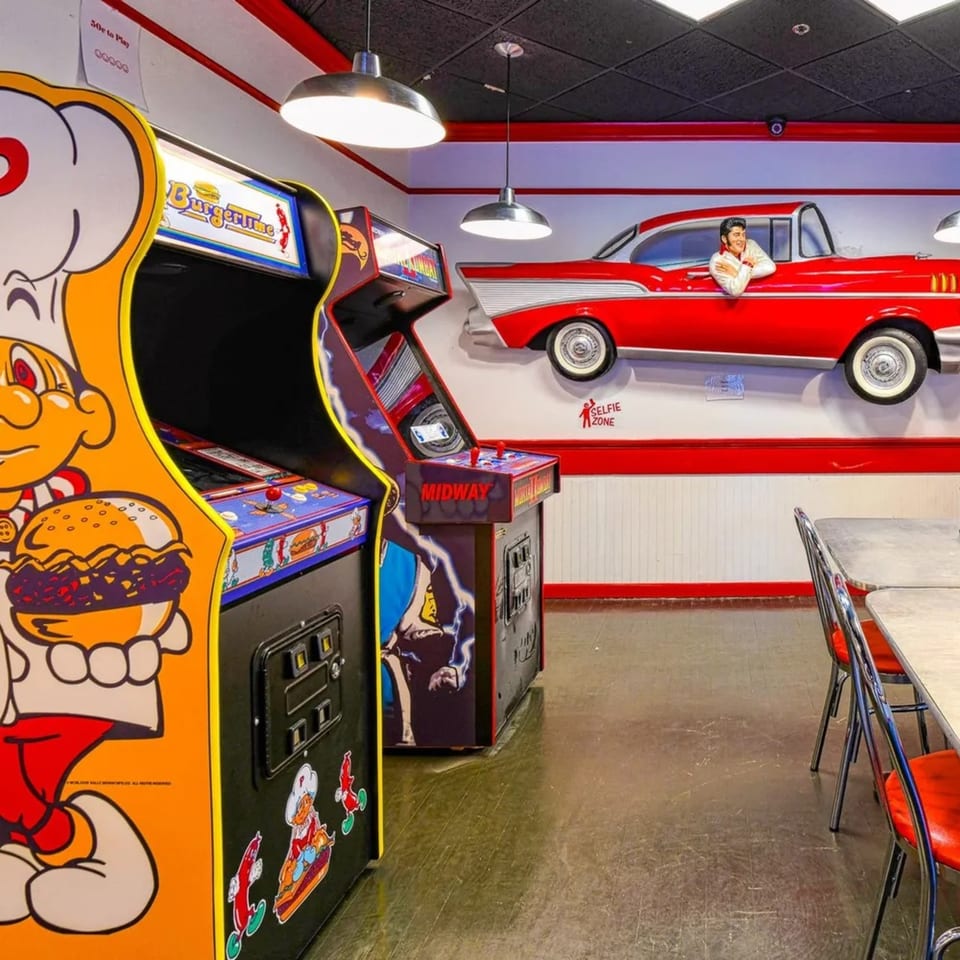 Arcade games, including BurgerTime, and a red classic car wall decoration in a retro diner.